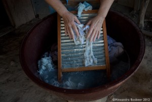 Nun in Honduras using a washing board for the thrice weekly laundry.
